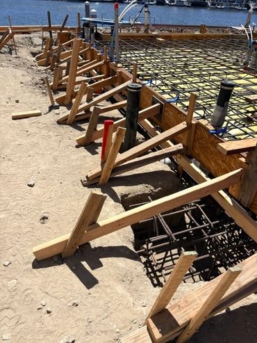 Close-up of wood formwork and steel reinforcement before a concrete slab pour.