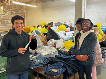 Teens helping organize donations for a Community Ambassador Project