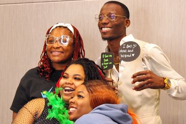 Teens and instructors taking photos at our Teen Peace Summit photobooth