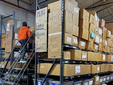 Teen helping organize donations for a Community Ambassador Project