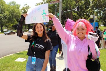 Teen walking with their sign during our Peace Walk at our Teen Peace Summit