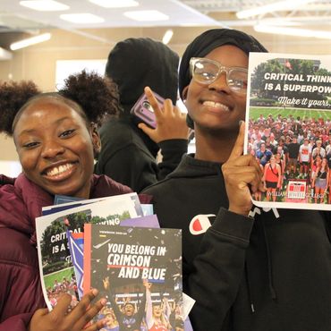 Teens posing with their college flyers at our College & Career Day