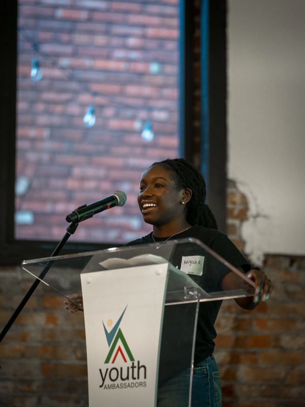 Ambassador, Aniyah, giving a speech as she accepts her award
