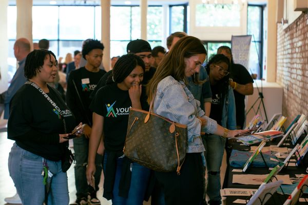 Teens and guests looking at our Ambassadors' art
