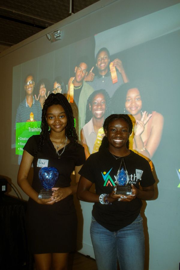 Ambassadors, Aniyah and TraShell posing with their awards