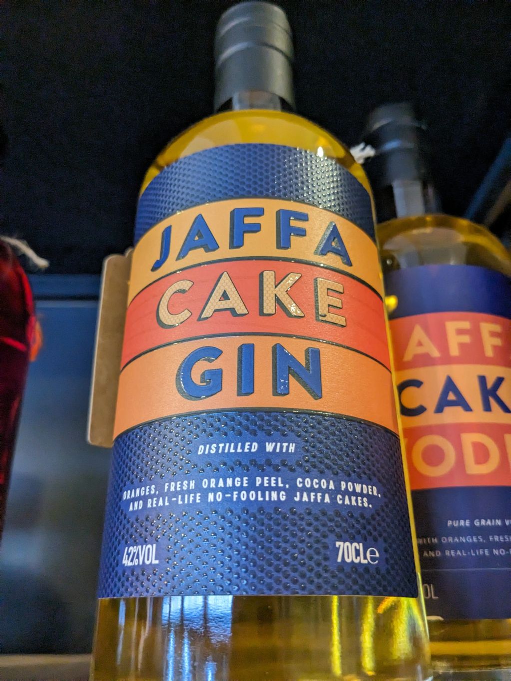 Bottle of Jaffa Cake Gin with bold colorful label.