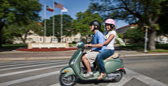 TCU College students riding Vespa scooter in Fort Worth Texas