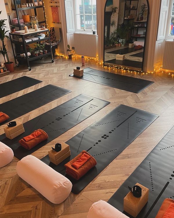Cozy yoga studio with mats, blocks, bolsters, and warm lighting. Inclusive Wellness Newcastle North shields whitley bay Tynemouth.