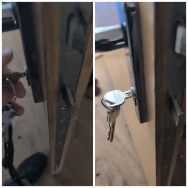 Person inserting and turning a key in a door lock.