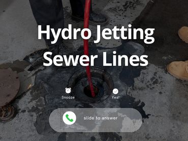 Hydro jetting service clearing a sewer line with high-pressure water.