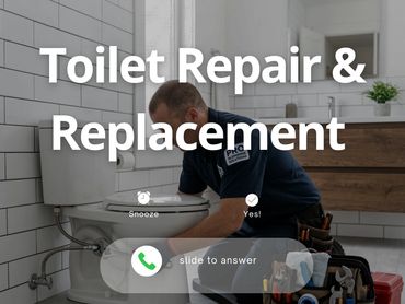 Plumber fixing a toilet with tools in a modern bathroom.