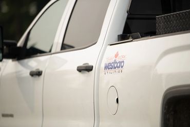 White utility truck with 'Westboro Utilities' logo and Canadian maple leaf.
