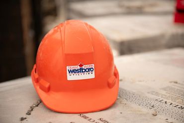 Orange construction helmet with Westboro Utilities logo.