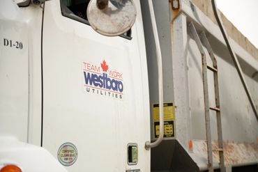Close-up of a white utility truck with Westboro Utilities logo and certification sticker.