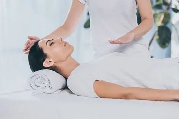 woman receiving a Reiki session