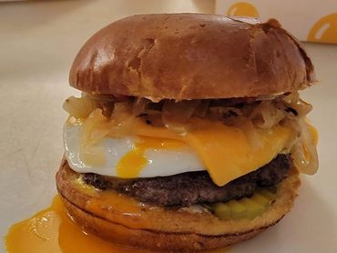 Custom burger blend of chuck, brisket & short rib,, cage-free over large egg, caramelized onions, ch