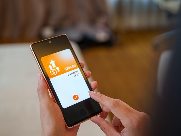Mobile Payment App Confirming Money Transfer on Smartphone Screen