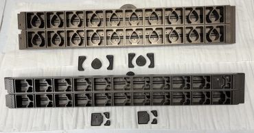 Several plastic mold trays with various shapes on a white surface.