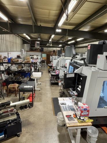 Inside a manufacturing workshop with machines and tools.