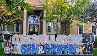 Kansas City graduation yard sign setup in residential front yard for surprise senior celebration