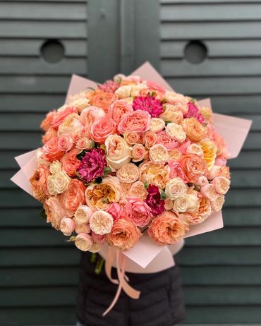 Soft peach and blush rose bouquet in warm pastel tones