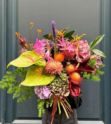 Vibrant bouquet with protea, hydrangea and seasonal accents