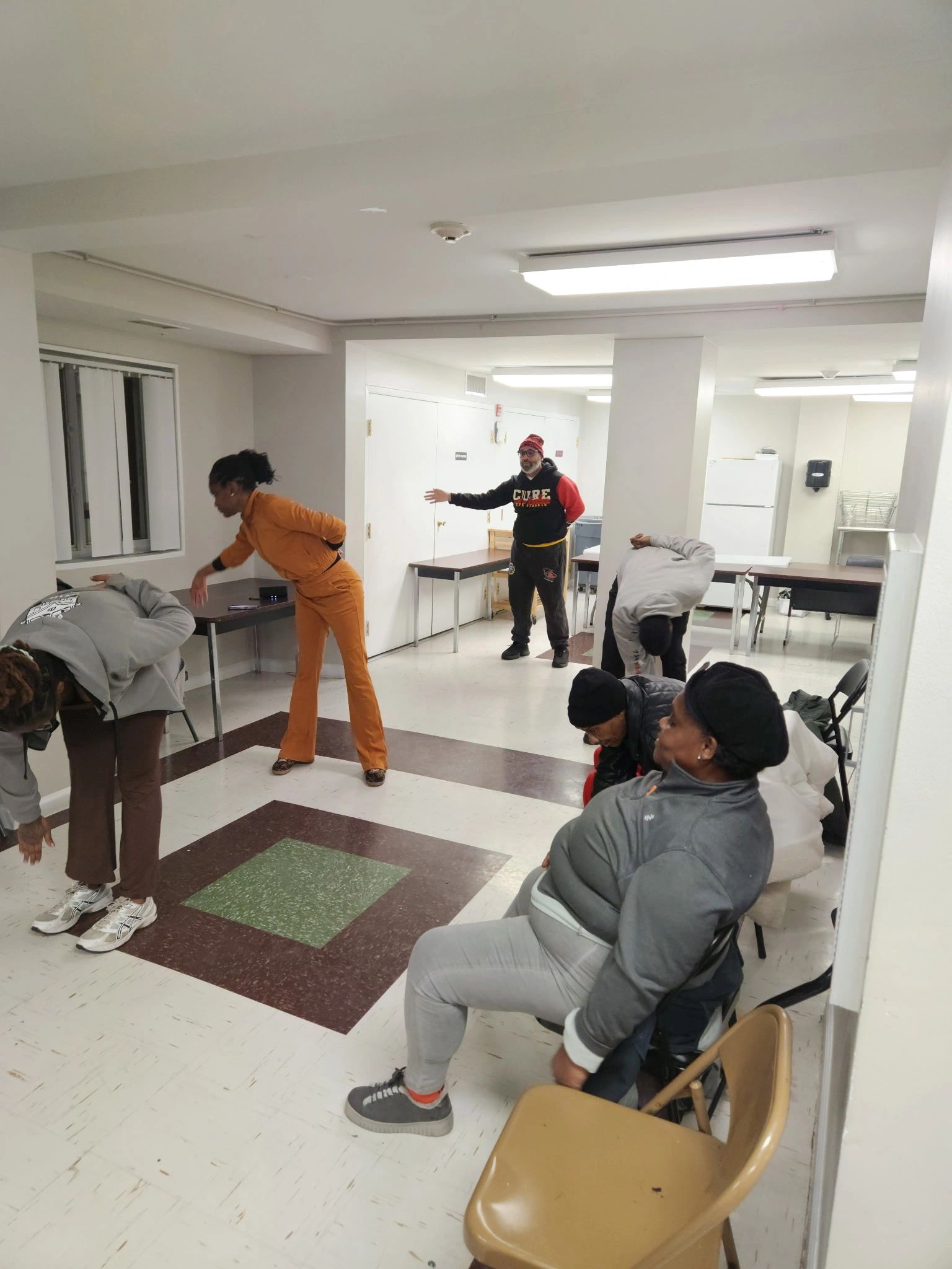 Group stretching in a community room.