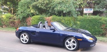 Porsche Boxter car standing on tarmac against a hedge in Roxton Bedford for sale on Auto Trader cars
