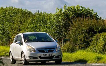 Vauxhall Corsa car being driven down a country road purchased from Cars R 4 Sale Ltd in Bedford
