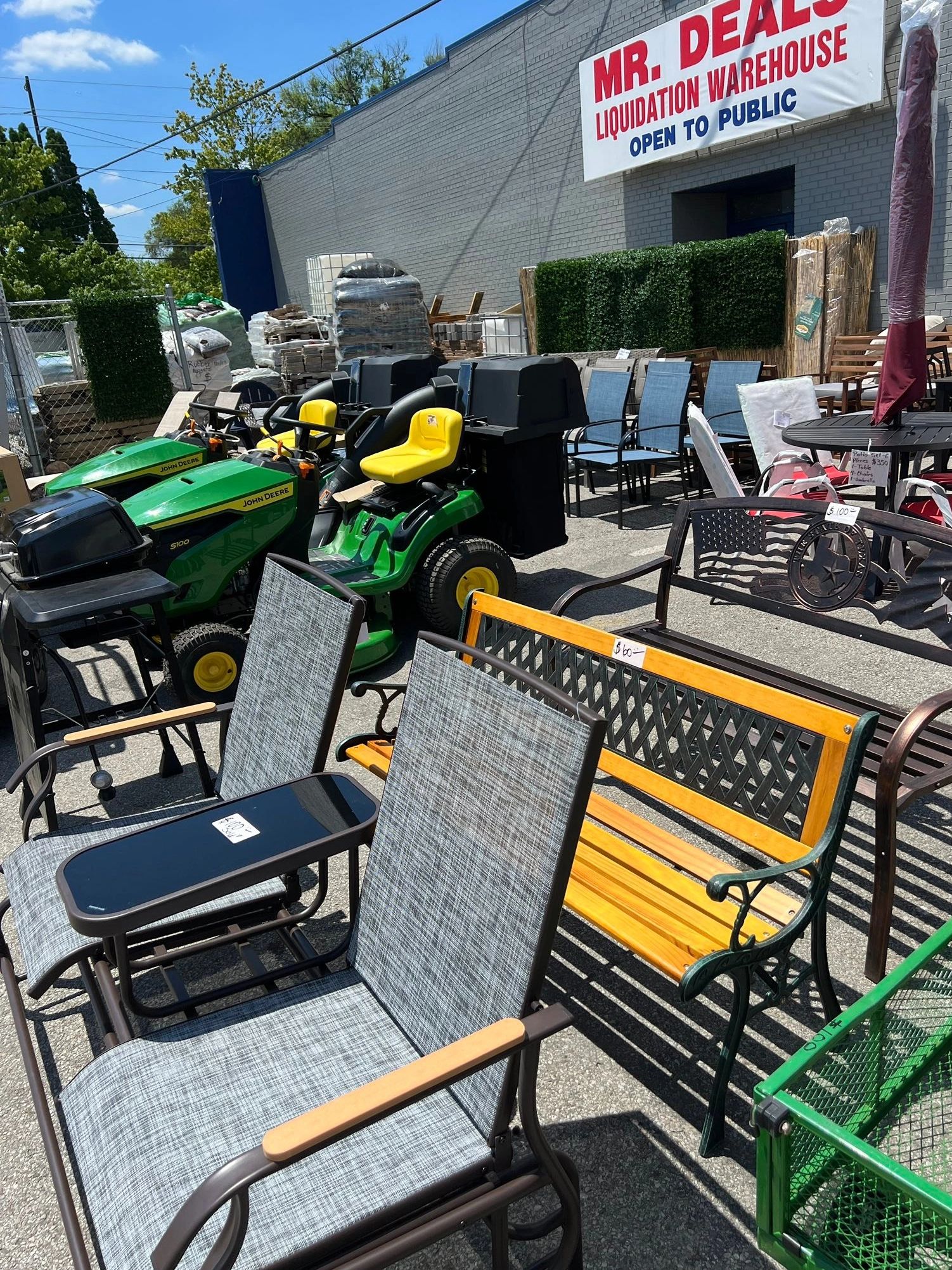 Patio furniture, lawn mowers, and home improvement inventory displayed outside the Mr. Deals Liquida