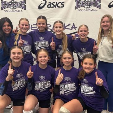 Girls volleyball team celebrating championship win.
