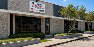Exterior view of Broadway Auto & Truck Sales building with signage and landscaping.