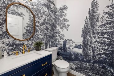 We turned a boring builder grade powder room into a stunning Graham & Brown wall moment.