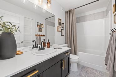 From builder grade to traditional timeless with gold accents, decor, and coat hooks for towels.