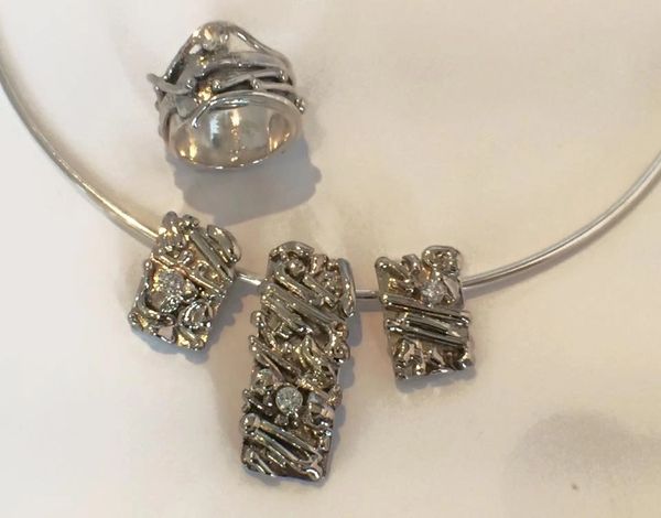 Due to a stroke her husband couldn't wear his wedding ring. White gold w/ diamonds from old pieces.