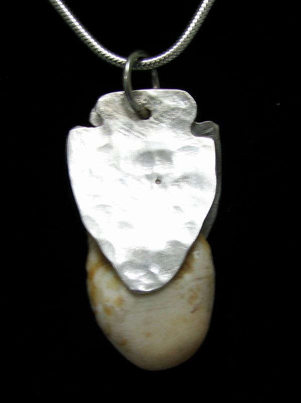 Elk tooth from first hunt as a boy w/ his father. Used bow & arrow.