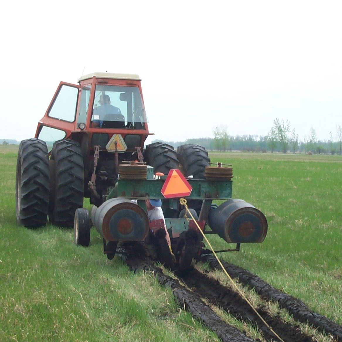 Person planting trees on tree planter