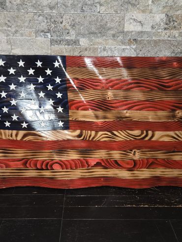 Wooden American flag with a natural wood grain finish.