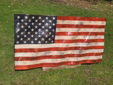 Wooden American flag artwork on grass