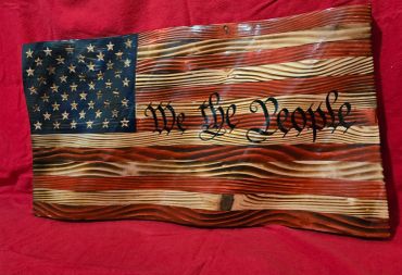 Wooden American flag artwork with "We the People" text.
