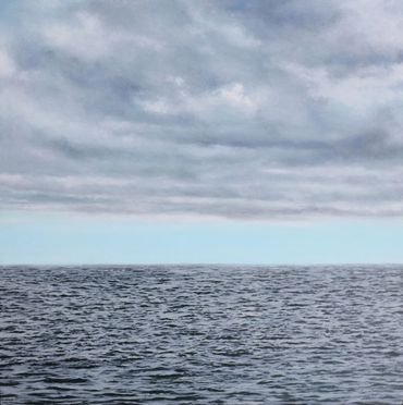 Painting of the water with grey clouds, blue sky on the horizon