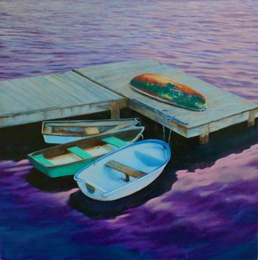 Dinghies tied to a dock, purple sunset, in Maine