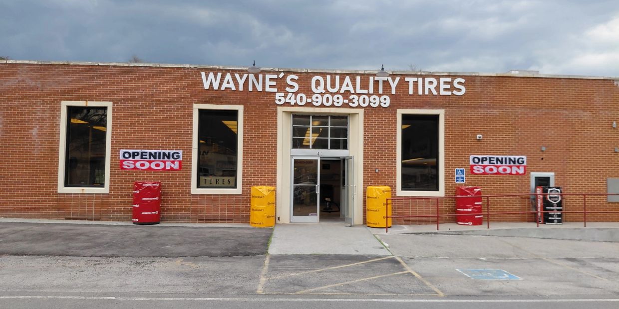 Wayne's Quality Tires store exterior with 'Opening Soon' signs.