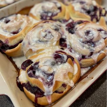 Freshly baked blueberry cinnamon rolls with glaze.