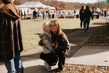 A woman and child pose at Cajun Gras