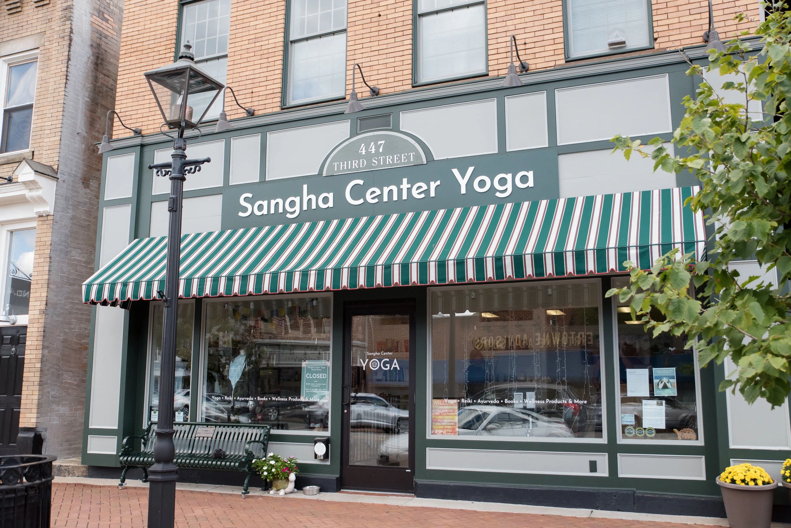 A storefront image of Sangha Center for Yoga and Wellness.