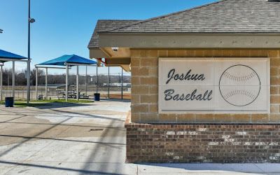 Baseball field entrance with Joshua Baseball sign.
