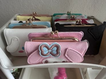 Collection of colorful coin purses with metallic clasps.