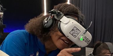 People wearing NASA suits and VR headsets exploring virtual space experiences.