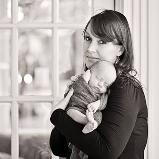 Mother holding her newborn baby in her arms.